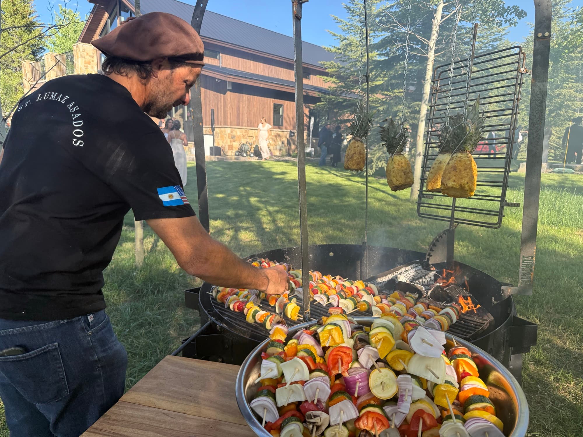 Colorful vegetable skewers and pineapple grilling over the open fire
