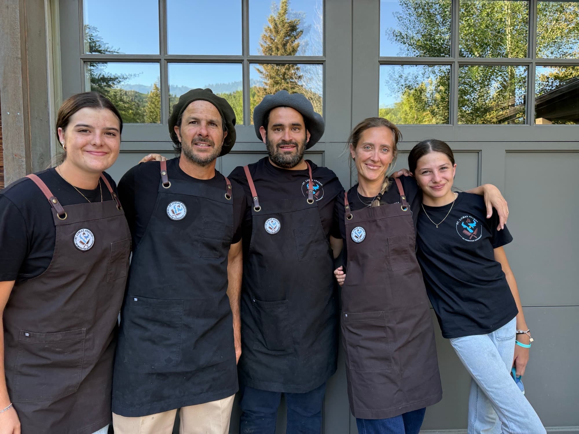 The St Lumaz Asados family lined up together in their aprons before an evening service